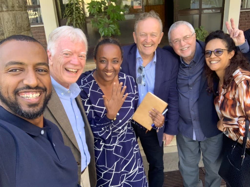 Youth Unashamed leaders and partners smiling together outside a gathering